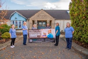 HSCP staff holding a banner appealing for people to come and work with them