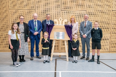 Pupils, staff and invited guests with the plaque to mark the official opening of the new East Calder Primary