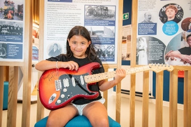 This guitar was donated and signed by Andy Mooney, the CEO of Fender Musical Instruments Corporation. Mooney was born in Whitburn and is the son of a miner. From 1999 to 2011 he worked at Disney, where he pioneered the Disney Princesses.